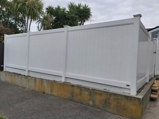 Epsom PVC privacy fence with trellis top, 1830mm high x 2400mm wide panel. Available in white or with grey insert panels. Grey insert style, classic design to complement New Zealand homes and can be matched with gates.