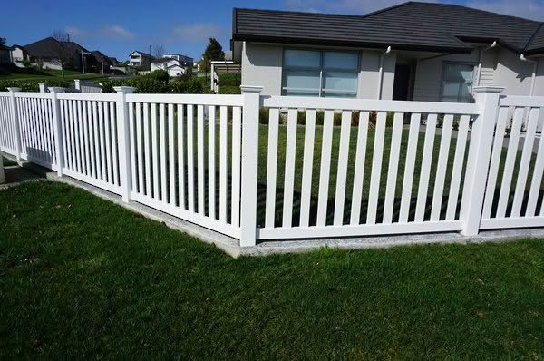 MED PVC pool fencing, 1200mm high x 2400mm wide panels. Versatile design suitable as perimeter or pool fence. When used for pools, complies with New Zealand pool regulations with compliant gate options. Shown with garden landscaping.