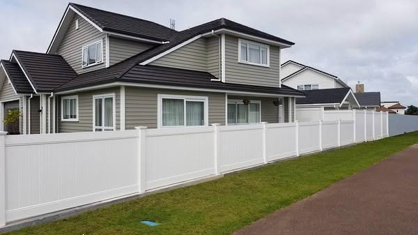 Metro PVC full privacy fence in white or grey, 1830mm high x 2400mm wide panel, durable and low-maintenance. Displayed as a grey boundary fence, ideal for New Zealand conditions, can be stepped or sloped.