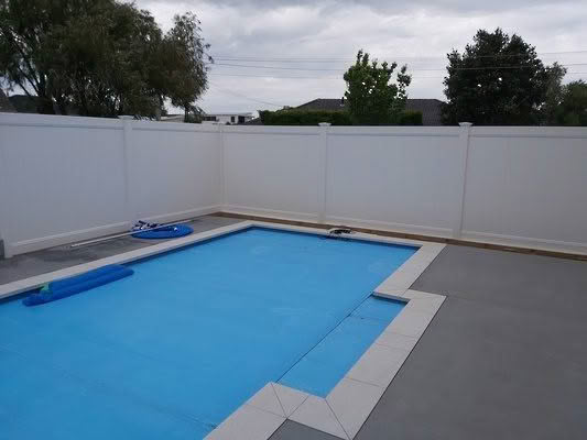 Metro PVC full privacy fence in white or grey, 1830mm high x 2400mm wide panel, durable and low-maintenance. Captured on a sunny day, suitable for New Zealand conditions, can be stepped or sloped.