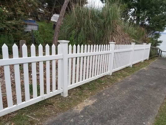 Villa PVC picket fence, 1200mm high x 2400mm wide panels. Provides a classic look with pickets centred through top and bottom rails, ensuring the same style on both sides. Installed at a modern home, low-maintenance and available with matching gates.